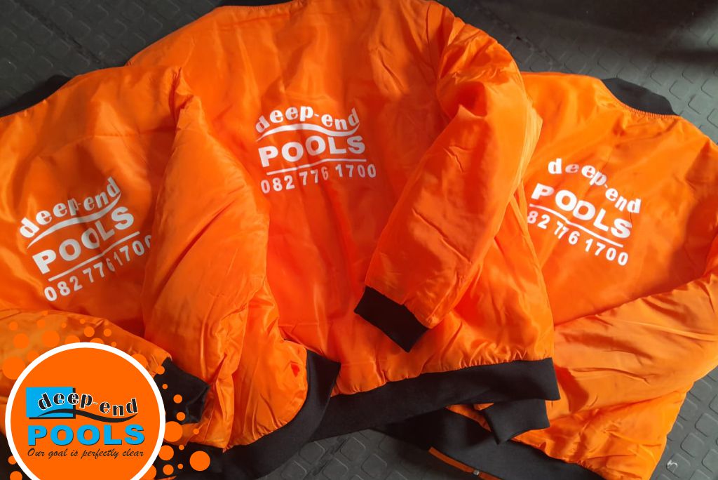 Deep-End-Pools-Branded-Orange-Safety-Jackets-Team-Gear Deep End Pools branded orange safety jackets and life vests with company logo and contact details. Professional team uniforms for pool renovation and maintenance in Wellington and the Cape Winelands.