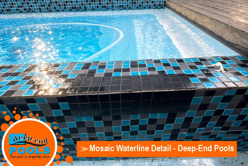 deep-end-pools-mosaic-waterline-black-teal-tile-detail Close-up of a Deep End Pools mosaic waterline, with black and teal glass tiles in a chequerboard pattern and sunlight on the blue water above.